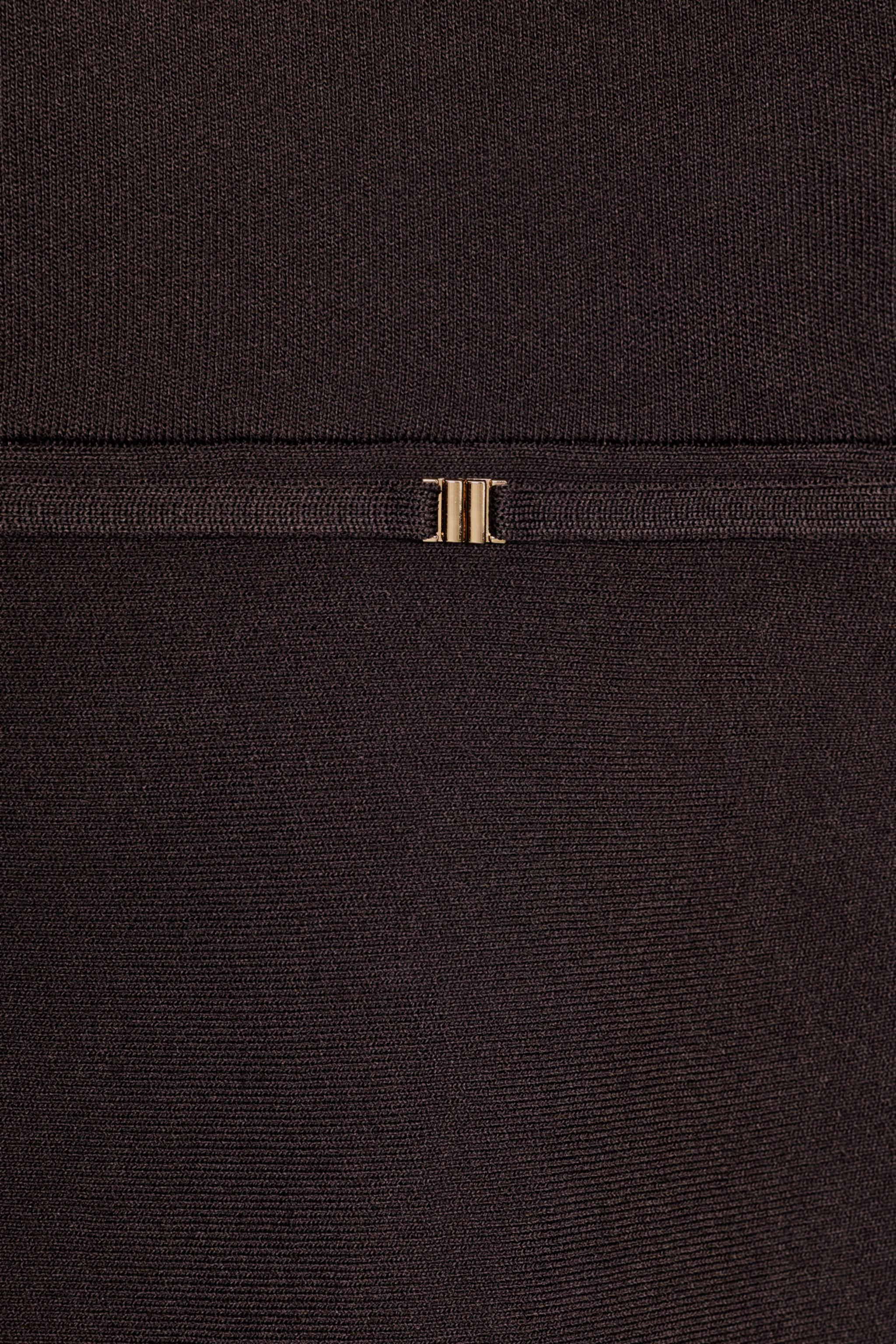 KNIT PEPLUM TOP WITH BELT